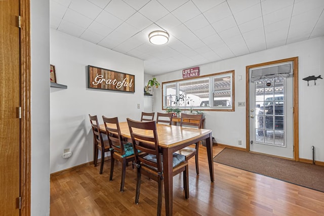 dining room featuring wood finished floors and baseboards