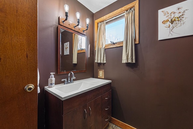 bathroom featuring baseboards and vanity