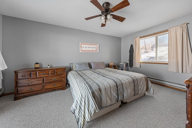 bedroom featuring a baseboard heating unit, a ceiling fan, carpet, and a textured ceiling
