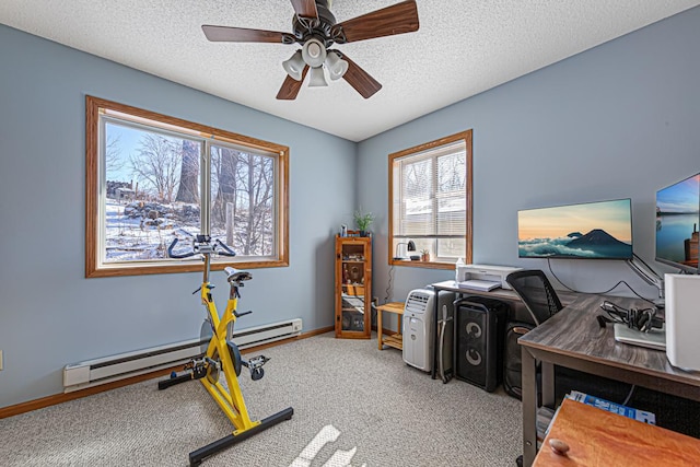 carpeted office space featuring a baseboard radiator, baseboards, a ceiling fan, and a textured ceiling