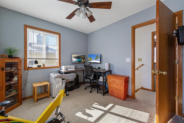 office space with carpet floors, baseboards, and ceiling fan
