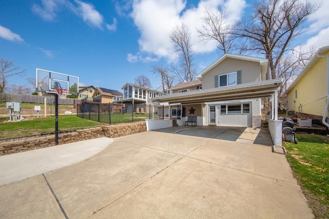 view of front of home with fence, driveway, and a front yard