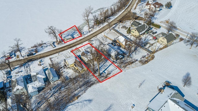 snowy aerial view with a residential view