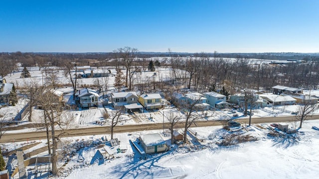 snowy aerial view with a residential view