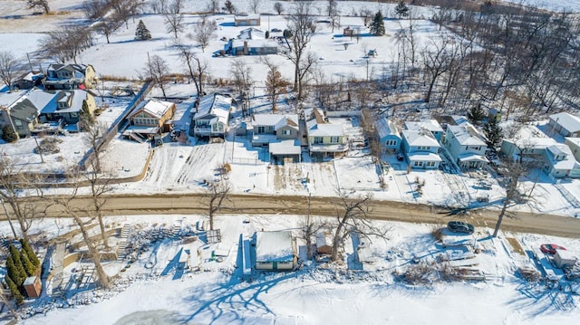 snowy aerial view featuring a residential view