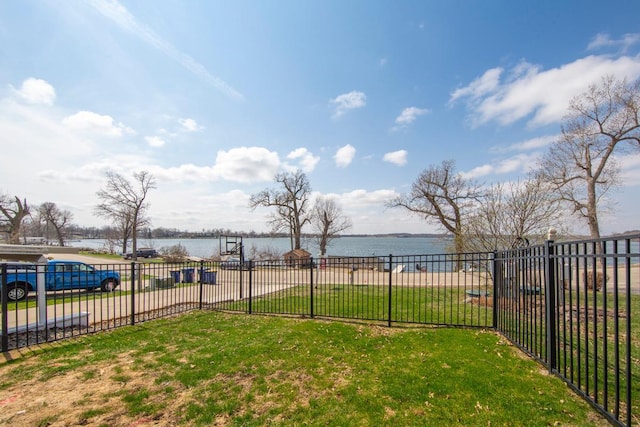 view of yard featuring fence and a water view