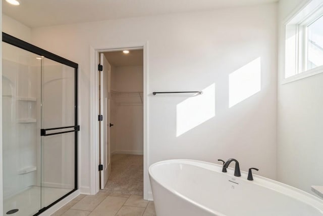 bathroom with tile patterned floors and independent shower and bath