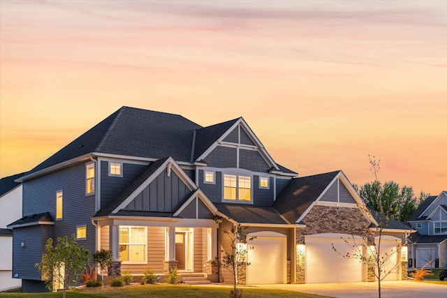 view of front of home with a garage and a yard