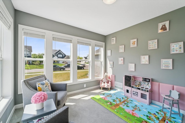 game room featuring plenty of natural light and carpet floors