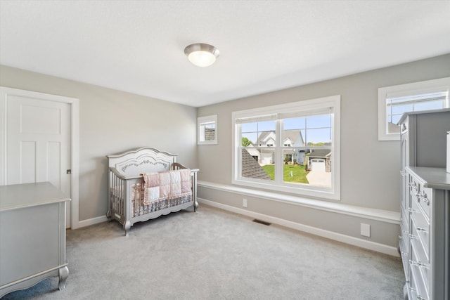 bedroom featuring light colored carpet