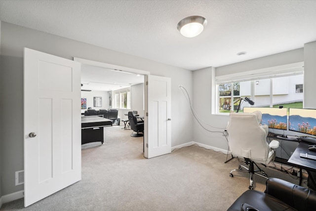 office area with light carpet and a textured ceiling