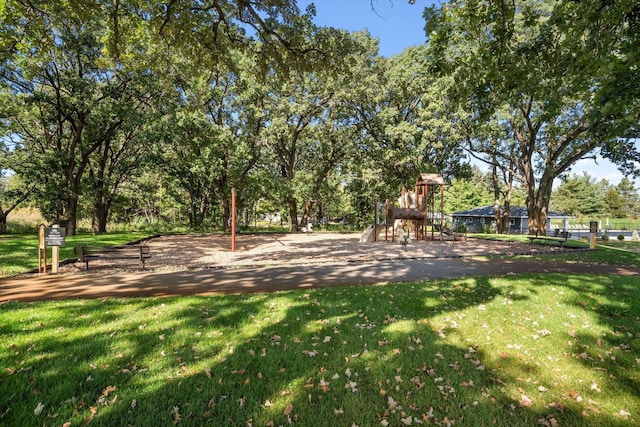 view of community featuring a playground and a lawn