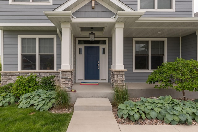 992 Southwell Enclave NE, Byron, MN 55920 - doorway to property featuring stone siding and covered porch