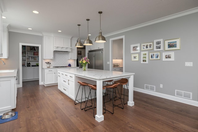 992 Southwell Enclave NE, Byron, MN 55920 - kitchen featuring ornamental molding, built in fridge, and visible vents