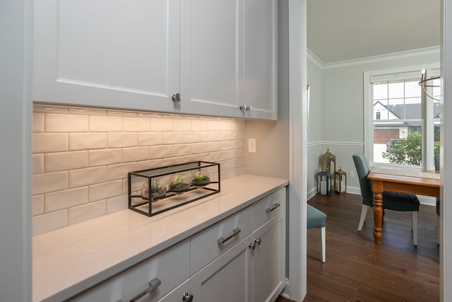 992 Southwell Enclave NE, Byron, MN 55920 - bar with baseboards, dark wood finished floors, backsplash, and crown molding