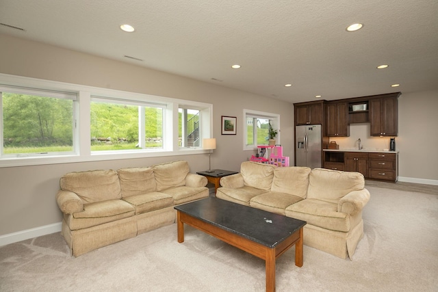 992 Southwell Enclave NE, Byron, MN 55920 - living area with baseboards, recessed lighting, light colored carpet, and wet bar