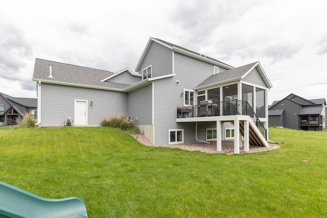 992 Southwell Enclave NE, Byron, MN 55920 - rear view of property featuring stairway, a lawn, a shingled roof, a wooden deck, and a sunroom