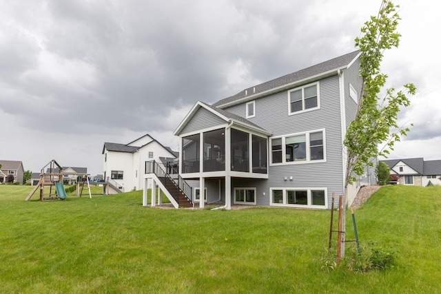 992 Southwell Enclave NE, Byron, MN 55920 - back of house with stairs, a sunroom, a playground, and a lawn