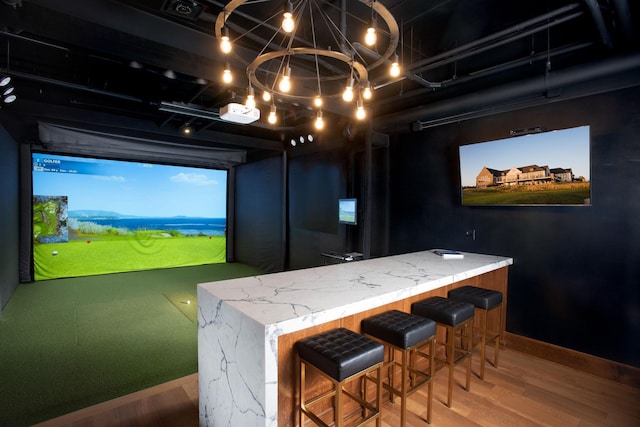 992 Southwell Enclave NE, Byron, MN 55920 - interior space featuring golf simulator, baseboards, and wood finished floors