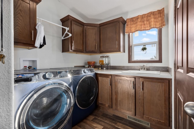 laundry room with sink, dark wood-type flooring, cabinets, and washing machine and clothes dryer