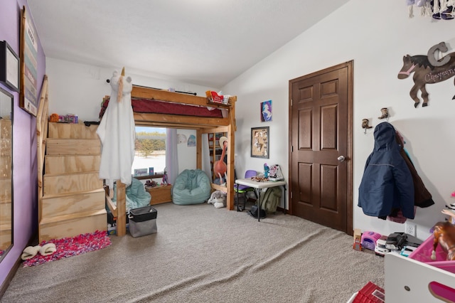 carpeted bedroom with lofted ceiling