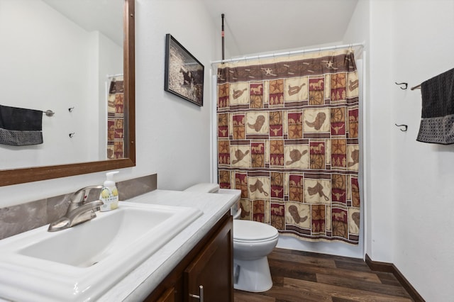 bathroom with wood-type flooring, walk in shower, vanity, and toilet