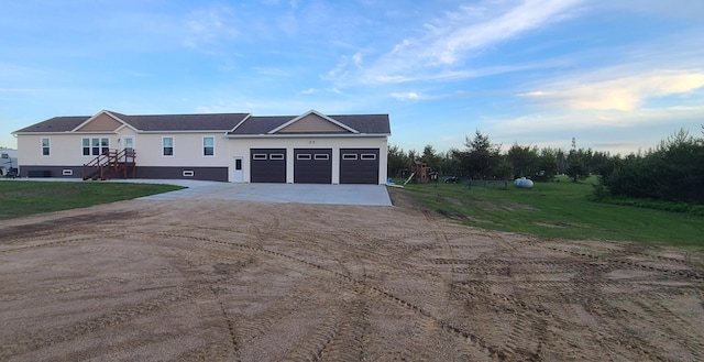 view of front of home featuring a garage and a front lawn