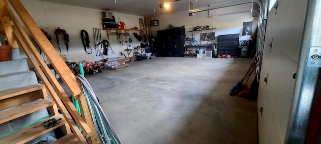 garage featuring a garage door opener and a workshop area