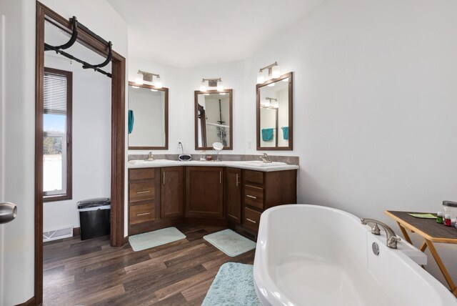 15743 County Road 31, Menahga, MN 56464 - bathroom featuring wood finished floors, a freestanding tub, and double vanity