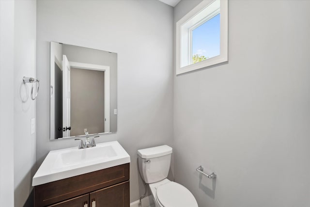 bathroom featuring toilet and vanity