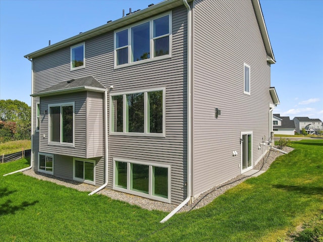 rear view of property with a lawn