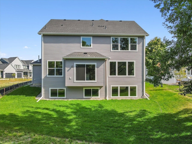 rear view of property featuring a yard