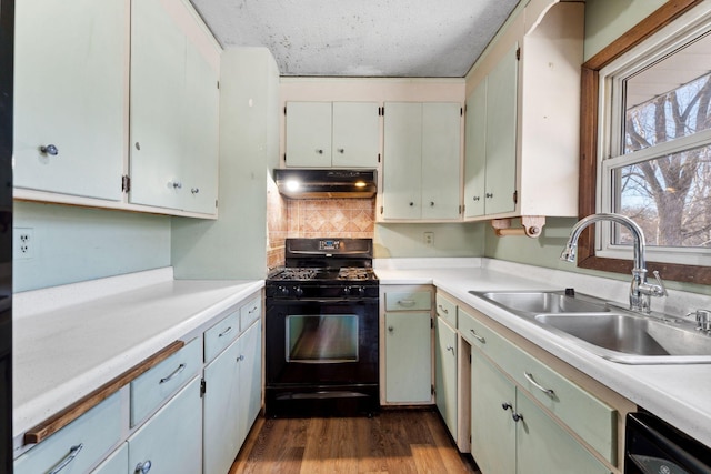 kitchen featuring sink, white cabinetry, dark hardwood / wood-style floors, decorative backsplash, and black appliances