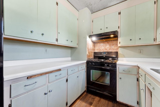 kitchen featuring white cabinetry, black gas stove, dark wood-type flooring, and backsplash