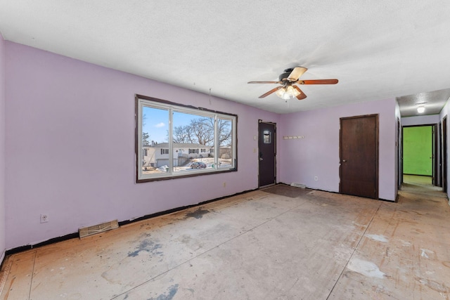 unfurnished room featuring ceiling fan and a textured ceiling