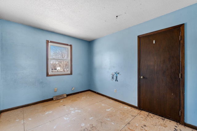 spare room with a textured ceiling