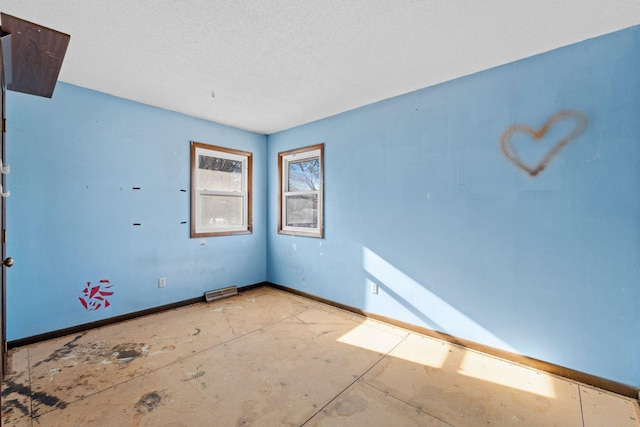 spare room with a textured ceiling