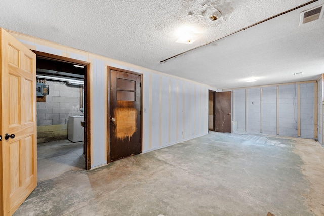 interior space featuring washer / dryer and a textured ceiling