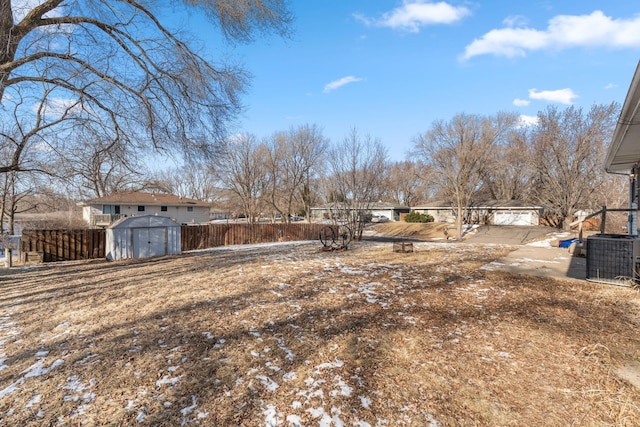 view of yard featuring central AC and a shed