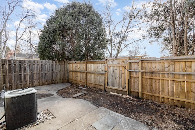 view of patio / terrace featuring a fenced backyard, central air condition unit, and a gate