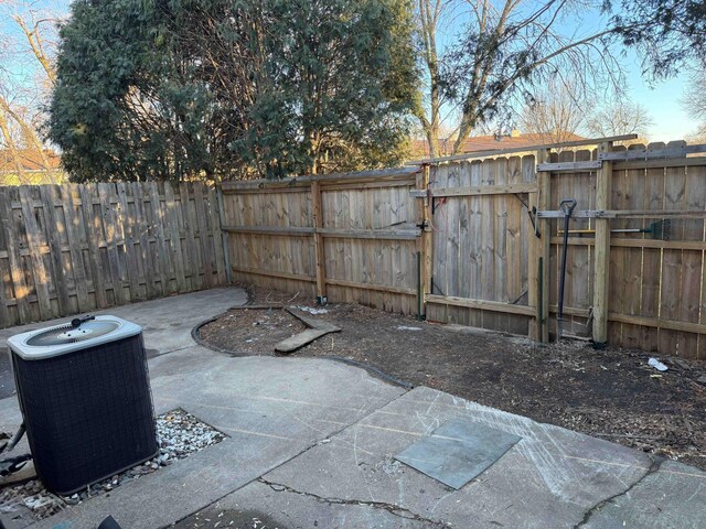 view of patio with a gate, a fenced backyard, and cooling unit