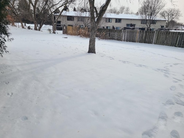 snowy yard with fence