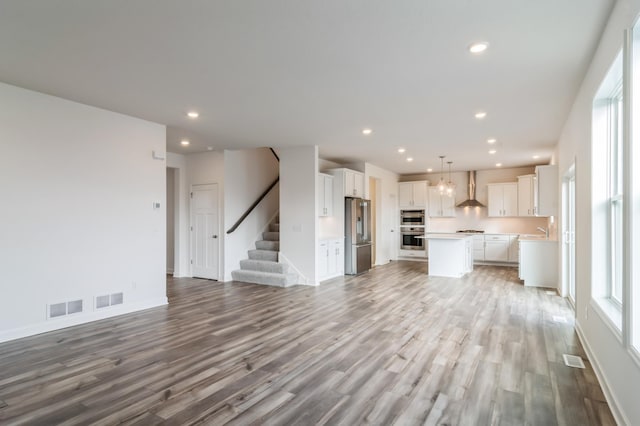 unfurnished living room featuring hardwood / wood-style floors