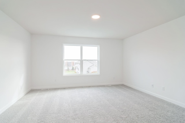 unfurnished room with light carpet