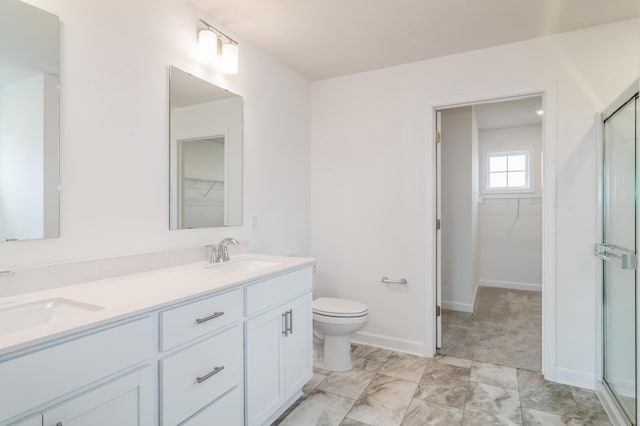 bathroom featuring an enclosed shower, vanity, and toilet