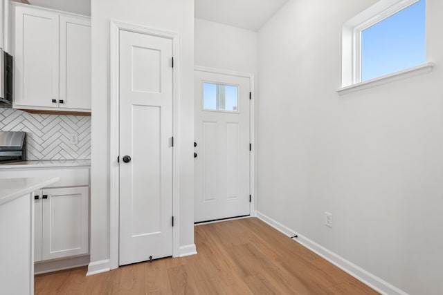 entryway featuring light hardwood / wood-style floors and a healthy amount of sunlight