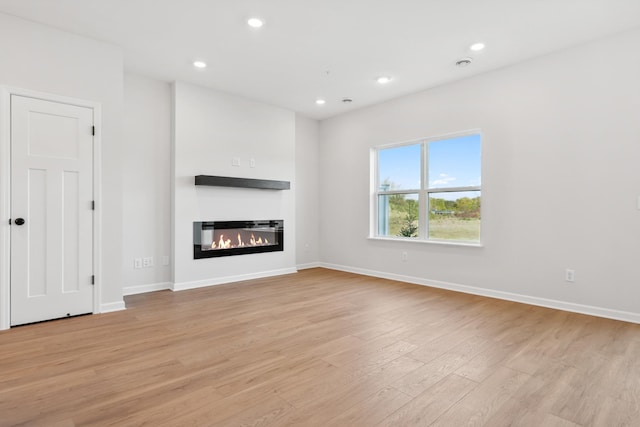 unfurnished living room featuring light hardwood / wood-style flooring