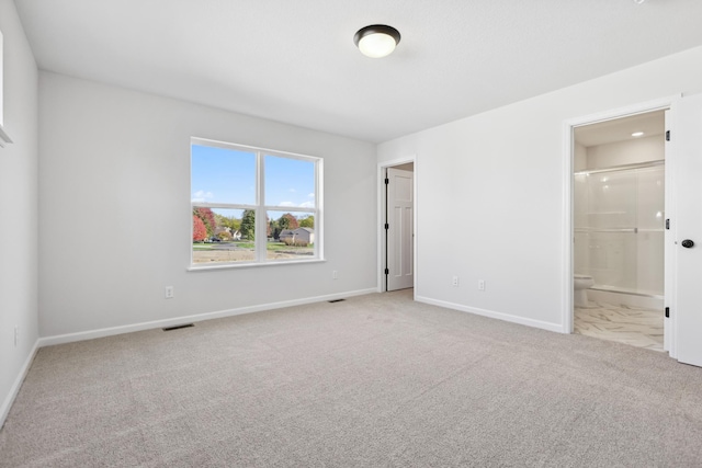 spare room featuring light carpet