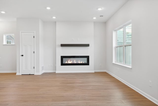 unfurnished living room featuring light hardwood / wood-style floors