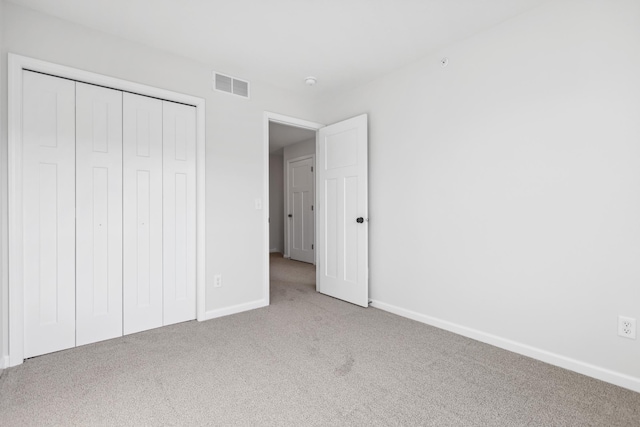 unfurnished bedroom with a closet and carpet flooring